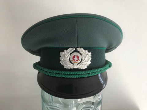 OBSOLETE EAST GERMAN NVA BORDER OR CUSTOMS POLICE UNIFORM CAP WITH BADGE